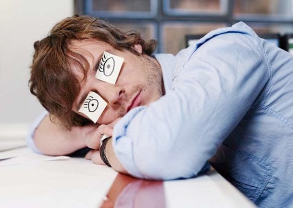 Young Man Sleeping with Drawn on Eyes --- Image by © Michael Haegele/Corbis