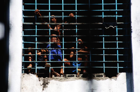 Brazil, Rio de Janeiro, Frei Caneca Prison, boys looking out of grills