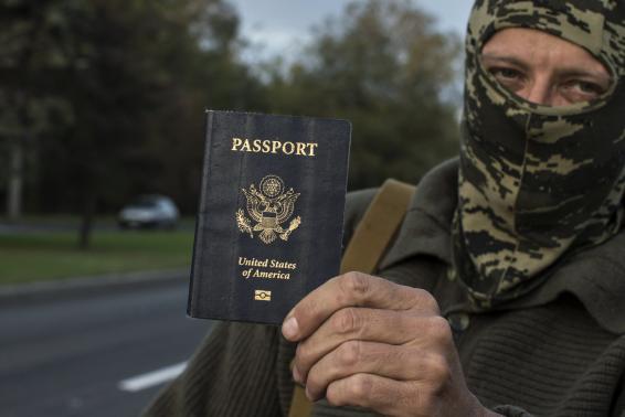 An American who calls himself "Hunter" holds his passport in Donetsk, eastern Ukraine